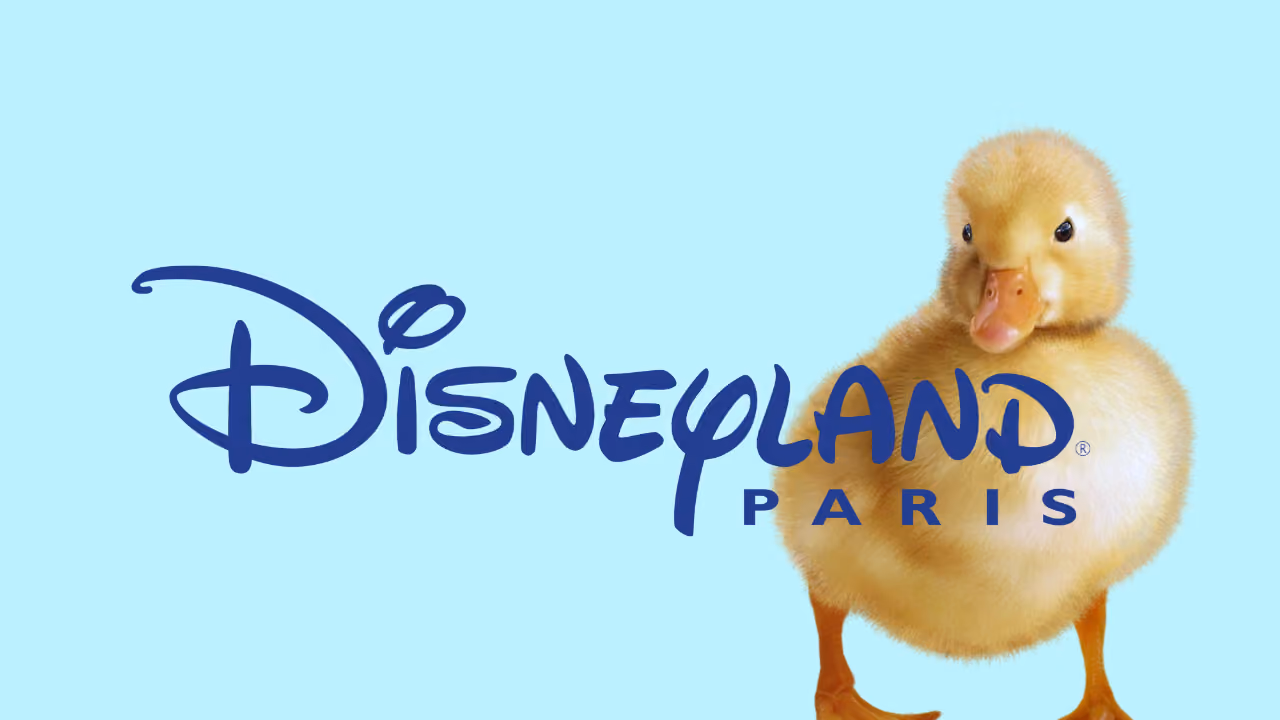 A duckling on pale blue beside the Disneyland Paris logo