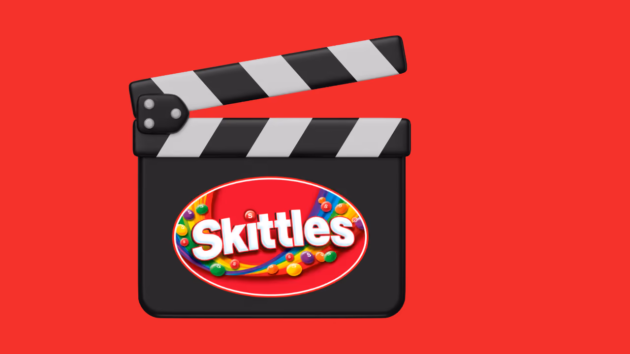 A clapperboard on red with the Skittles logo on its face