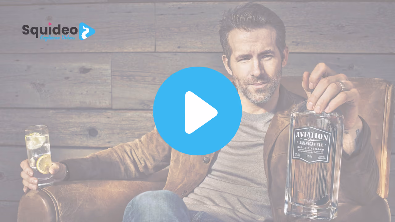 Ryan Reynolds in a leather armchair, a bottle of Aviation American Gin in one hand and a gin and tonic in the other