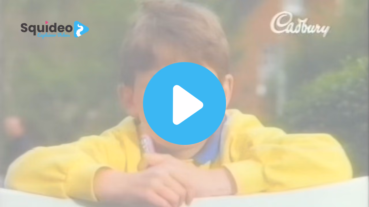 A boy in a yellow jumper leaning on a wall, the Cadbury script logo in the corner