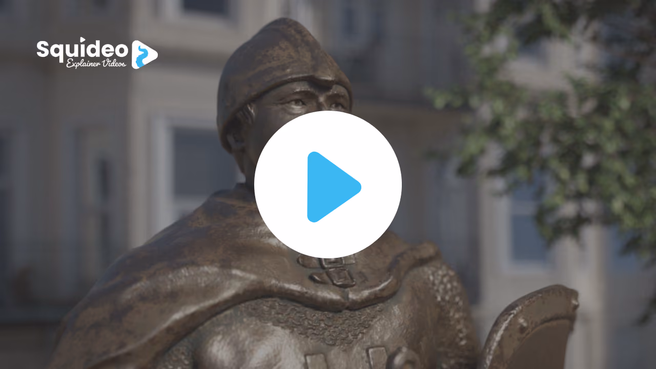 A bronze statue of a Norman soldier in a conical helmet and chainmail, a street of white houses blurred behind
