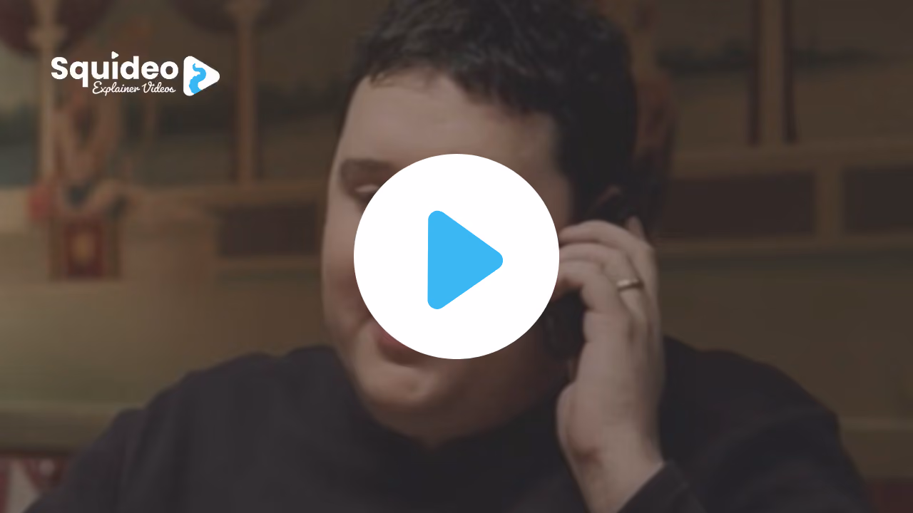 A man on a mobile phone in a pub, mid-sentence